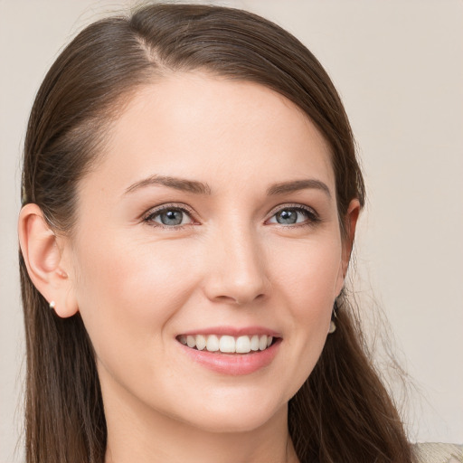 Joyful white young-adult female with long  brown hair and grey eyes