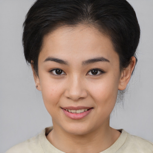 Joyful asian young-adult female with medium  brown hair and brown eyes