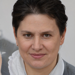 Joyful white adult female with short  brown hair and brown eyes