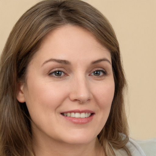 Joyful white young-adult female with long  brown hair and brown eyes