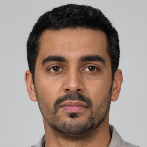 Neutral latino young-adult male with short  black hair and brown eyes