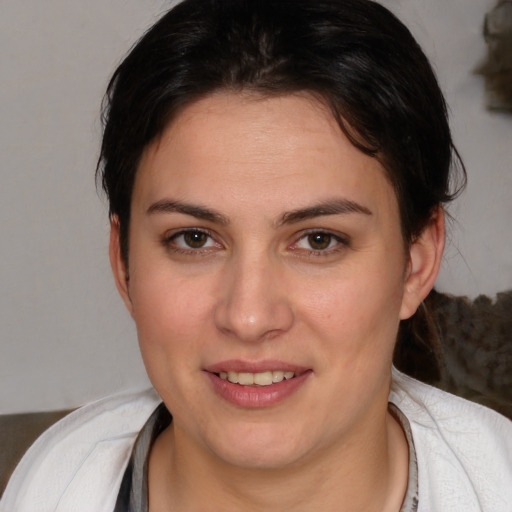 Joyful white young-adult female with medium  brown hair and brown eyes