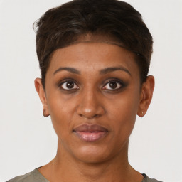Joyful black young-adult female with short  brown hair and brown eyes