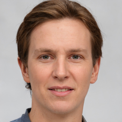 Joyful white adult male with short  brown hair and grey eyes