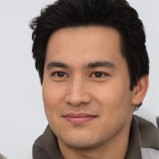 Joyful asian young-adult male with short  black hair and brown eyes