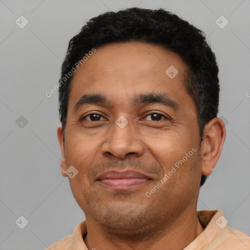 Joyful latino adult male with short  black hair and brown eyes