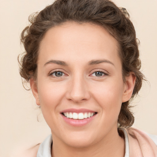 Joyful white young-adult female with medium  brown hair and green eyes