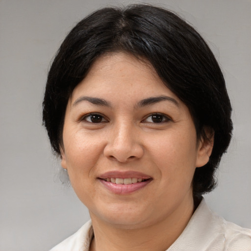 Joyful asian adult female with medium  brown hair and brown eyes