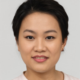 Joyful asian young-adult female with short  brown hair and brown eyes