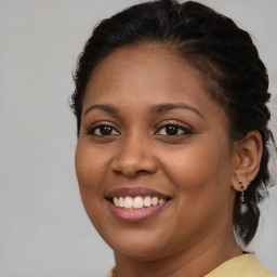 Joyful black young-adult female with medium  brown hair and brown eyes