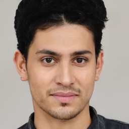 Joyful white young-adult male with short  black hair and brown eyes