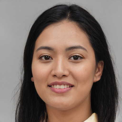 Joyful asian young-adult female with long  black hair and brown eyes