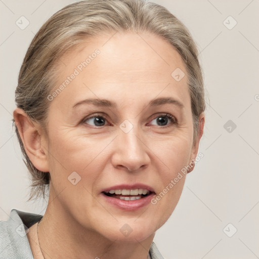 Joyful white adult female with medium  brown hair and grey eyes