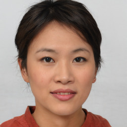 Joyful asian young-adult female with short  brown hair and brown eyes