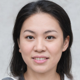 Joyful asian young-adult female with medium  brown hair and brown eyes