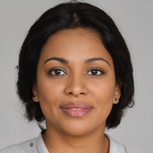 Joyful black young-adult female with medium  brown hair and brown eyes