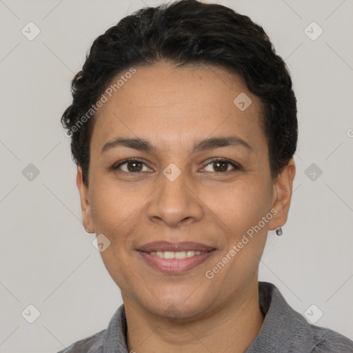 Joyful latino adult female with short  black hair and brown eyes