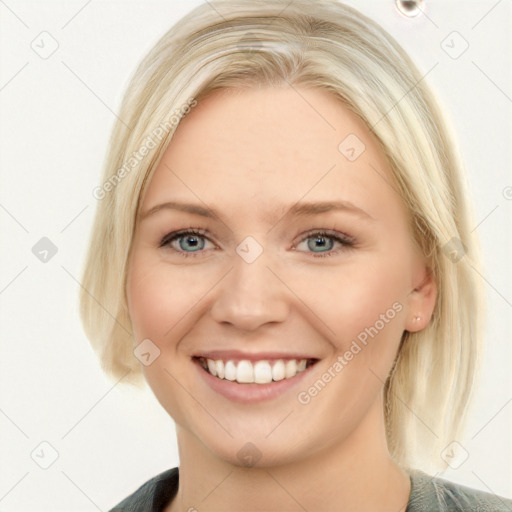 Joyful white young-adult female with long  brown hair and blue eyes