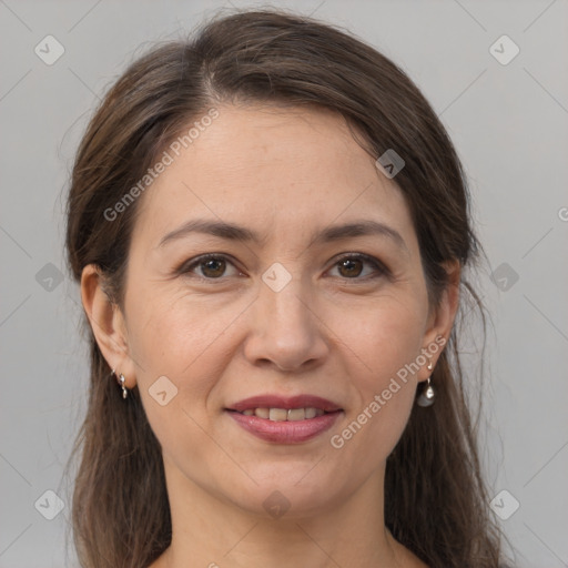 Joyful white adult female with long  brown hair and brown eyes