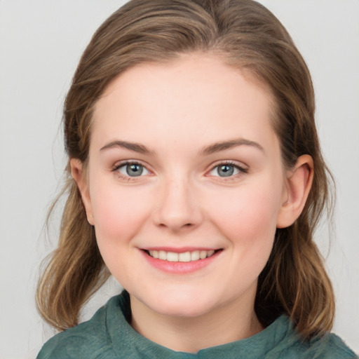 Joyful white young-adult female with medium  brown hair and blue eyes