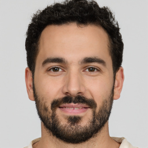 Joyful white young-adult male with short  black hair and brown eyes