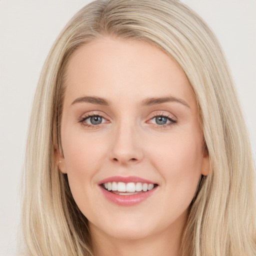 Joyful white young-adult female with long  brown hair and blue eyes