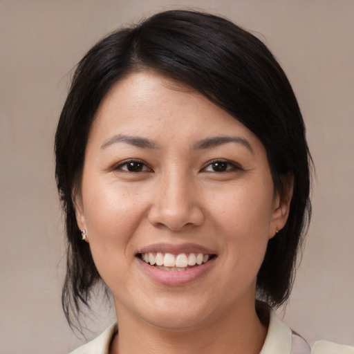 Joyful white young-adult female with medium  black hair and brown eyes