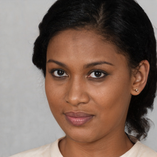 Neutral black young-adult female with medium  brown hair and brown eyes