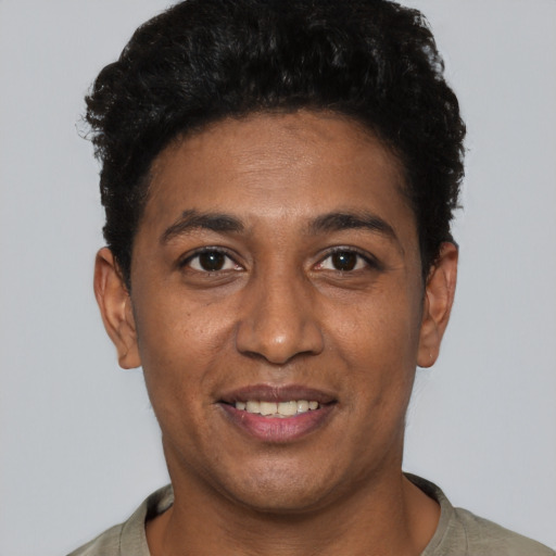 Joyful black young-adult male with short  black hair and brown eyes