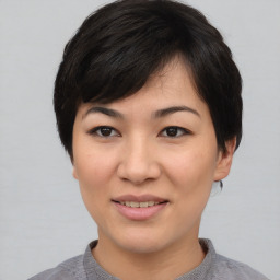 Joyful asian young-adult female with medium  black hair and brown eyes