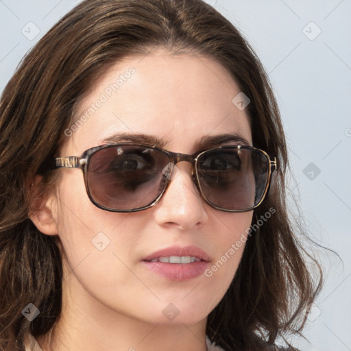 Joyful white young-adult female with long  brown hair and blue eyes