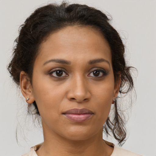Joyful black young-adult female with medium  brown hair and brown eyes