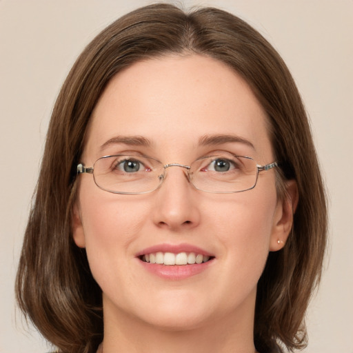 Joyful white adult female with medium  brown hair and green eyes