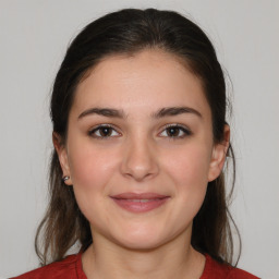 Joyful white young-adult female with medium  brown hair and brown eyes