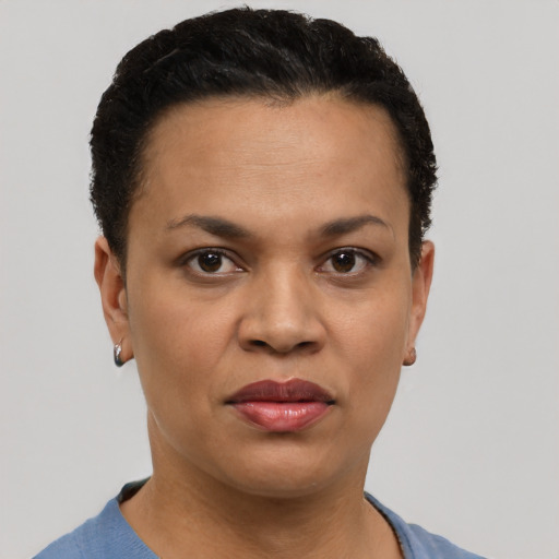 Joyful black adult female with short  black hair and brown eyes