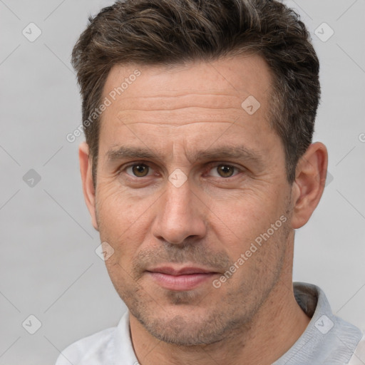 Joyful white adult male with short  brown hair and brown eyes