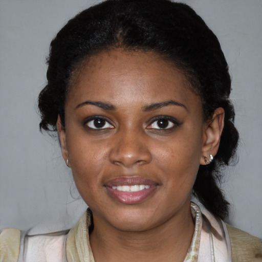Joyful black young-adult female with medium  black hair and brown eyes