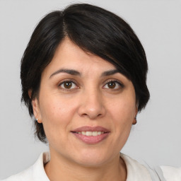 Joyful white adult female with medium  brown hair and brown eyes