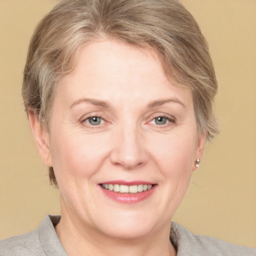 Joyful white adult female with medium  brown hair and grey eyes