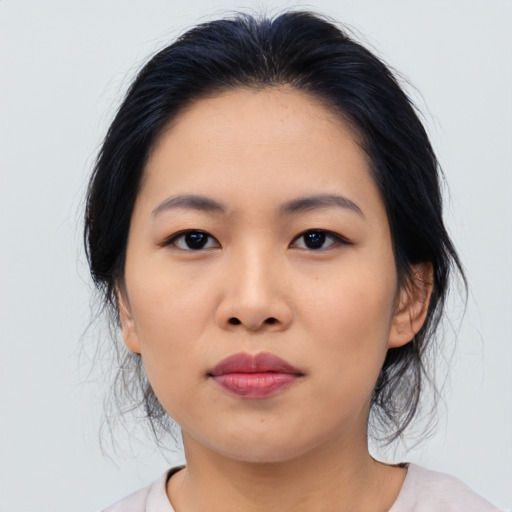 Joyful asian young-adult female with medium  black hair and brown eyes