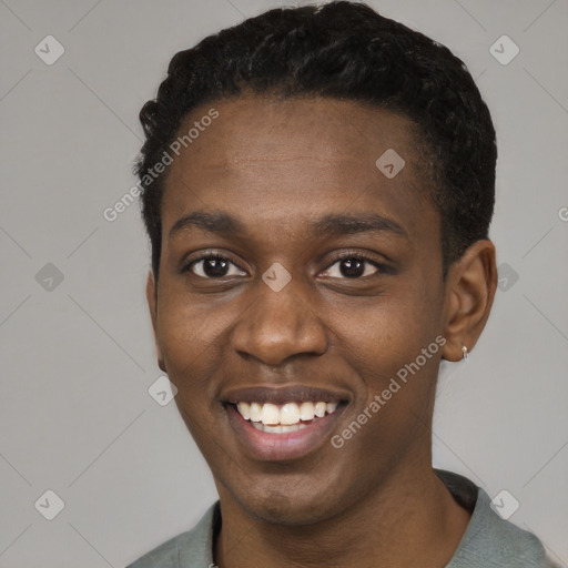 Joyful black young-adult male with short  black hair and brown eyes