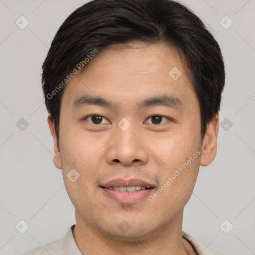 Joyful asian young-adult male with short  brown hair and brown eyes