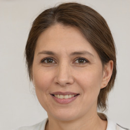 Joyful white adult female with medium  brown hair and brown eyes