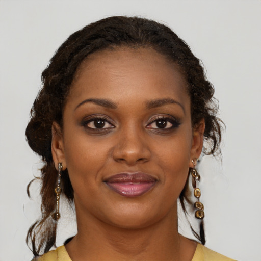 Joyful black young-adult female with medium  brown hair and brown eyes