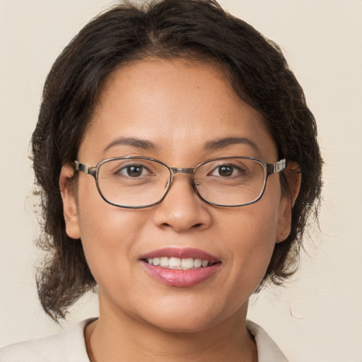 Joyful white adult female with medium  brown hair and brown eyes