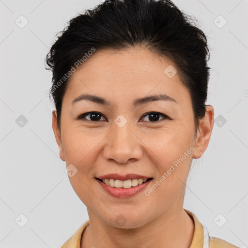 Joyful asian young-adult female with short  brown hair and brown eyes