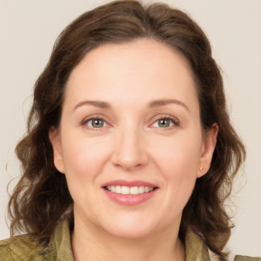 Joyful white young-adult female with medium  brown hair and green eyes