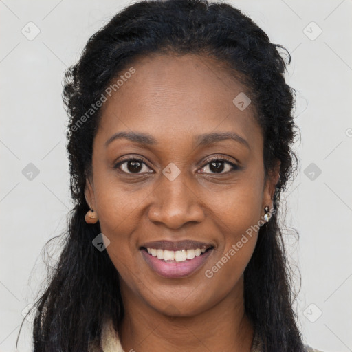 Joyful black young-adult female with long  black hair and brown eyes
