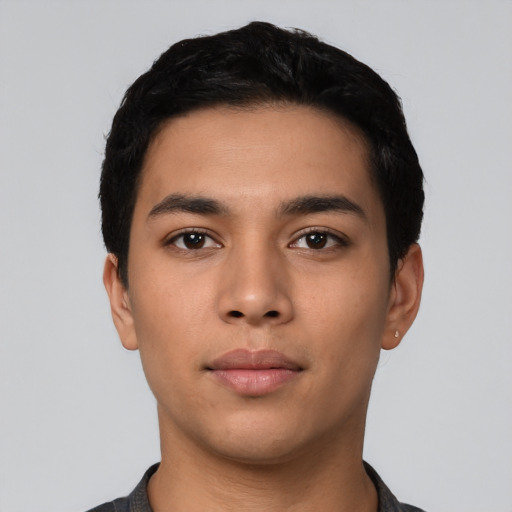 Neutral latino young-adult male with short  black hair and brown eyes