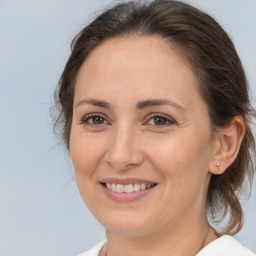 Joyful white adult female with medium  brown hair and brown eyes